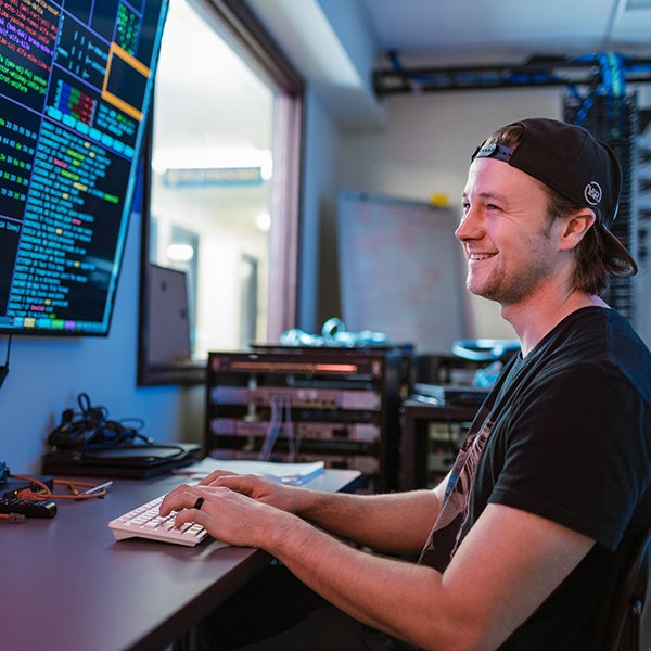 man at a computer writing code