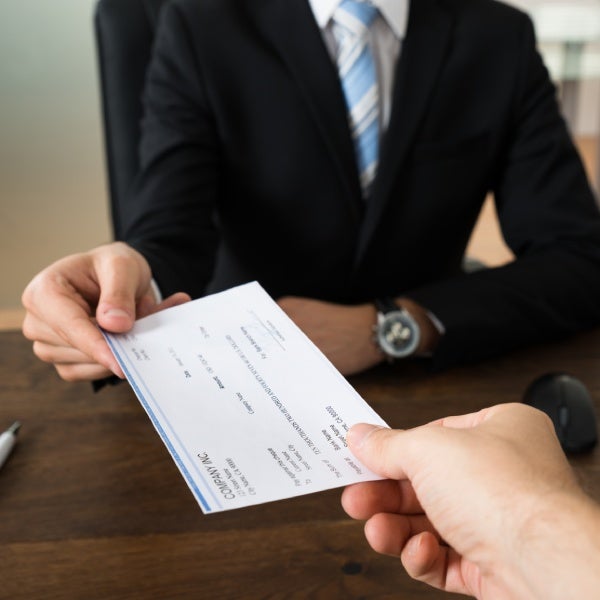 business man handing check to person