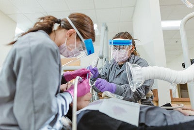 Dental assistants with patient