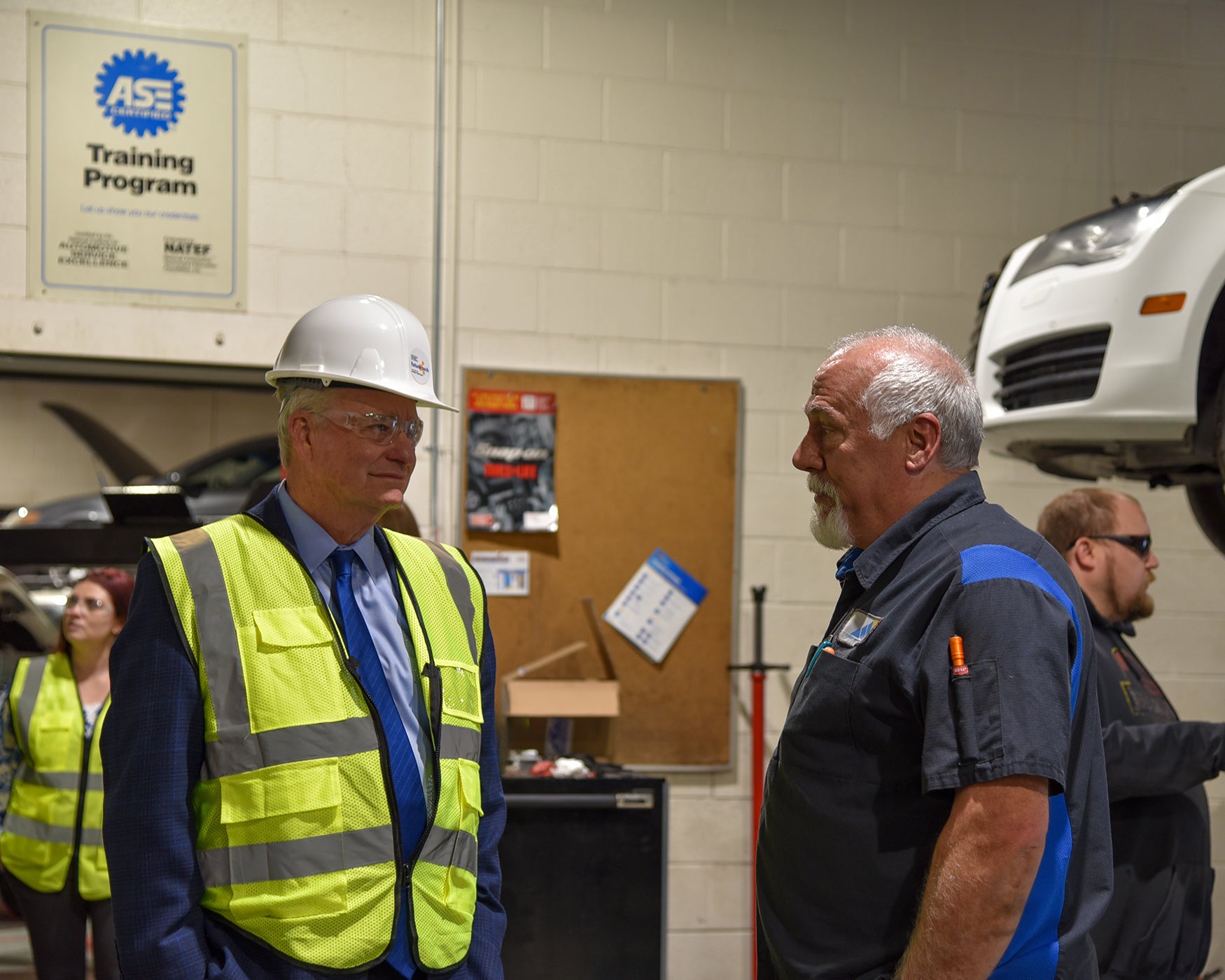 Governor Brad Little speaks with Kent Berggren, Department Chair of Trades and Industry, about the automotive technology program during his visit to College of Eastern Idaho.