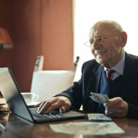 A man entering document information at a laptop