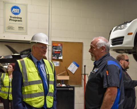 Governor Brad Little speaks with Kent Berggren, Department Chair of Trades and Industry, about the automotive technology program during his visit to College of Eastern Idaho.
