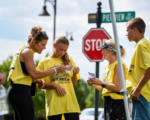 Runners interacting at a street corner