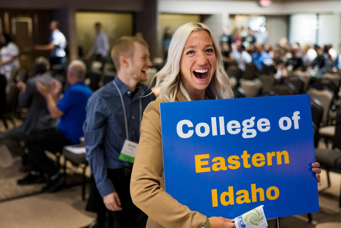 Student holding sign that says 'College of Eastern Idaho'