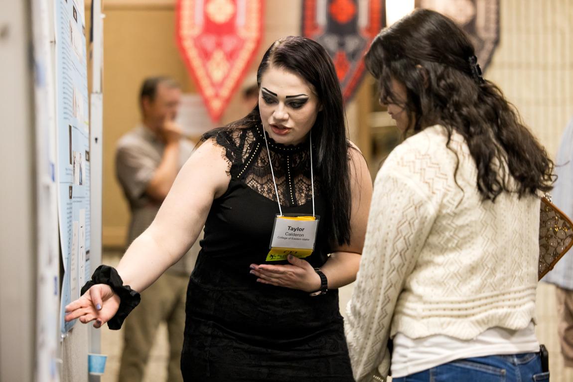 Student giving demonstration to an onlookers