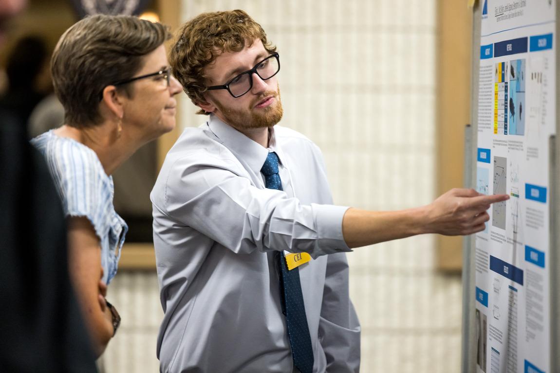 Student giving demonstration to an onlookers