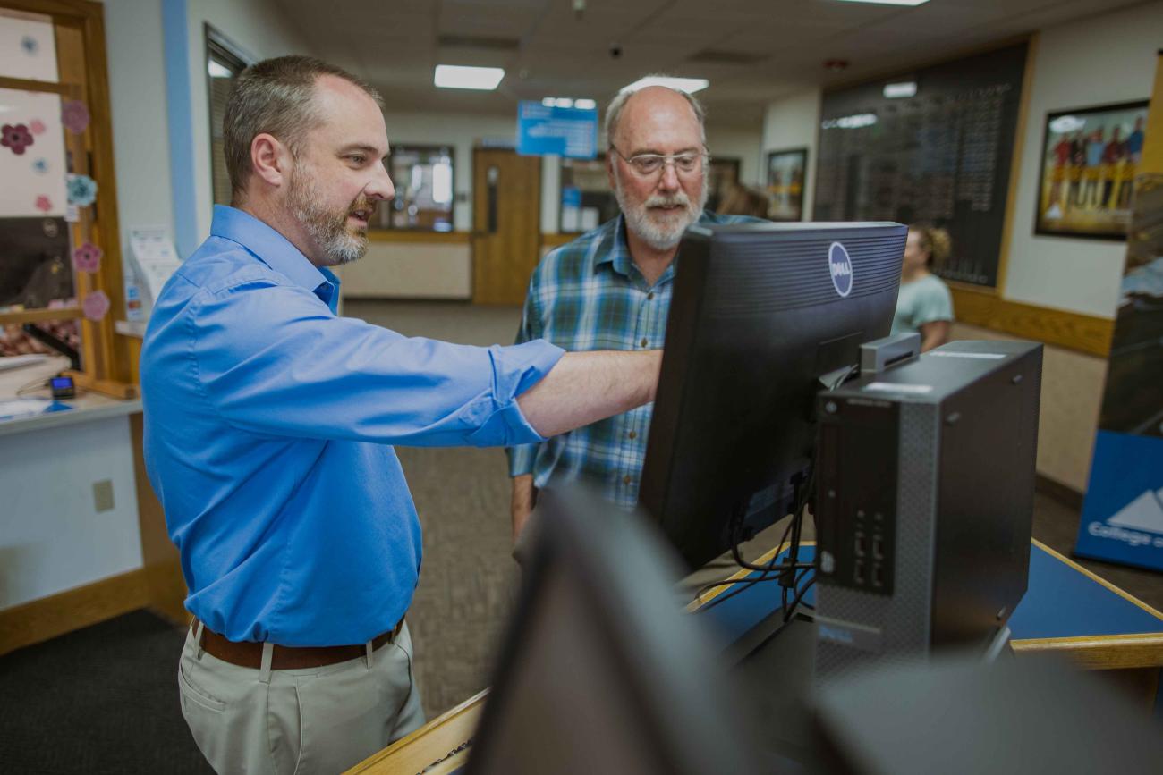 CEI employees at a computer