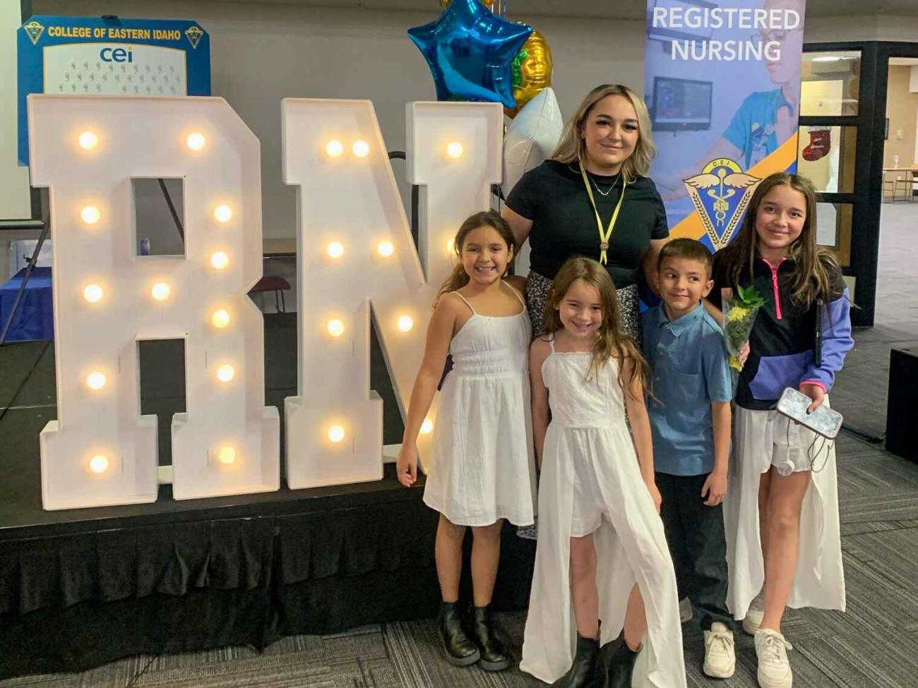 Caitlyn Keelin poses for photo with children