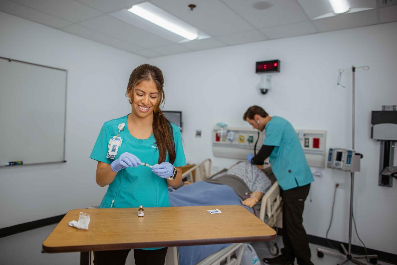Two registered nursing students practice clinical skills in the Nursing Simulation Lab at College of Eastern Idaho.