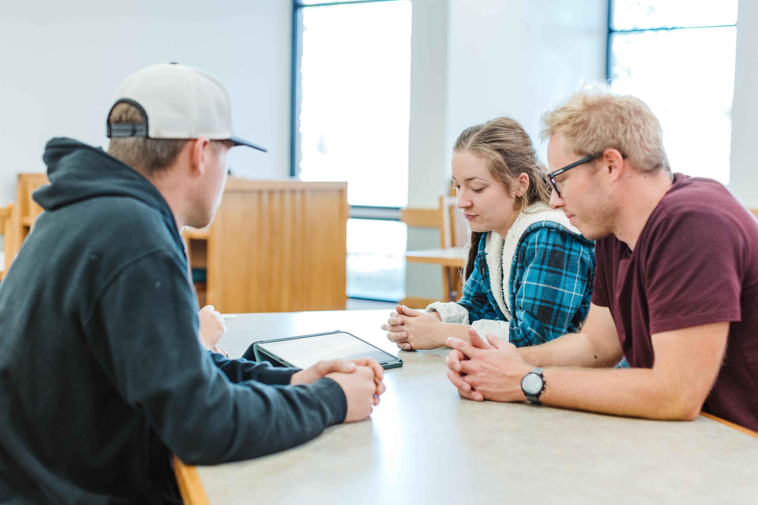 Students conversing over a table