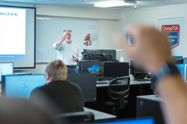IT Classroom Student raising their hand